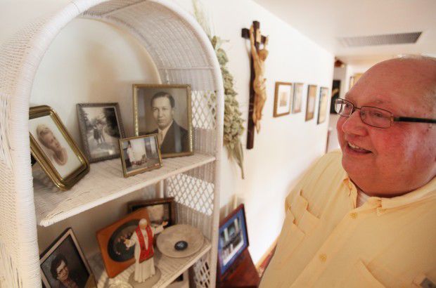 Bishop Robert Morlino points out family photographs